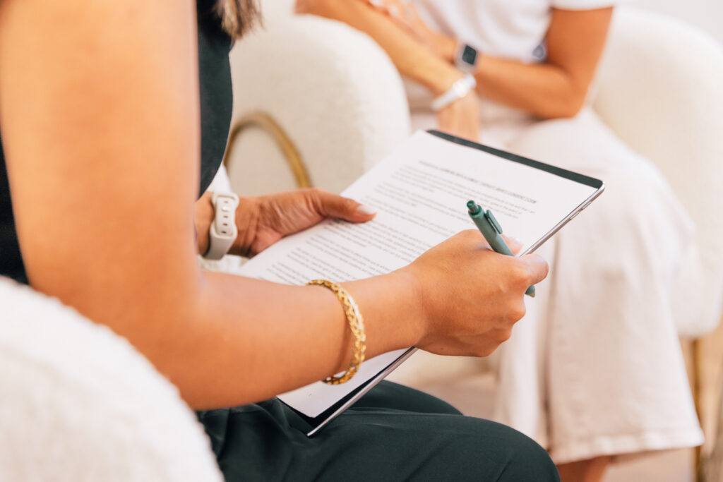 A patient sits with their provider at our weight loss clinic near Lenexa during this initial consultation. Her provider is working through some paperwork with her, which is often one of the first steps for treatment. 